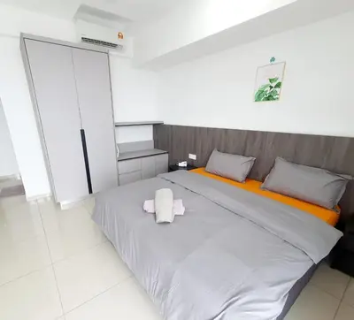 a large white bed with a stuffed animal on it at LOVELY 2ROOM SUITE6PAX@SKY CONDO JURU SENTRAL in Bukit Mertajam
