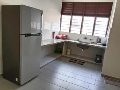a kitchen with a refrigerator and a sink at CLP perai homestay near Sri Muniswarar Temple 2 in Perai