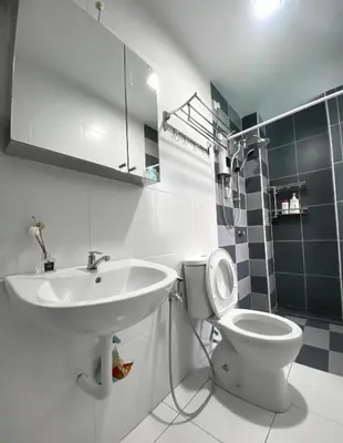 a bathroom with a sink and a toilet and a mirror at Comfy Suite Manhattan Ipoh PoolView Waterpark Free Netflix&Game in Ipoh