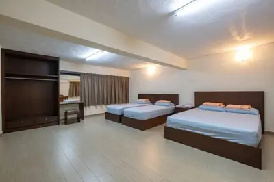 a hotel room with two beds and a television at CLP perai homstay in perai in Perai