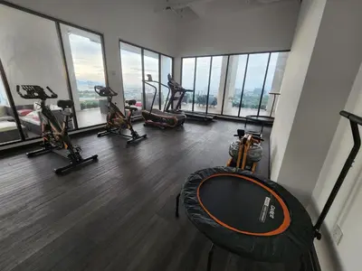 a gym with treadmills and exercise equipment in a building at Praicon Executive Suite in Butterworth