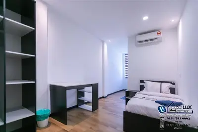 a small bedroom with a bed and a desk at Villa w/PrivatePool Golf View Snooker BBQ 10BR in Bayan Lepas