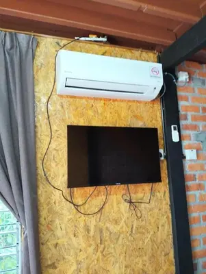 a wall with a heater and a television on it at D'RUMAH BONDA RIVER VIEW Kuala Kangsar in Kampong Senawar